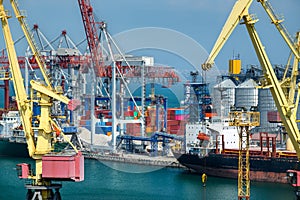 Industrial seaport infrastructure, sea, cranes and dry cargo ship, grain silo and bulk carrier vessel, concept of sea cargo