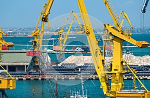 Industrial seaport infrastructure - sea, cranes and minerals, metal and bundles of wire, concept of marine cargo transportation