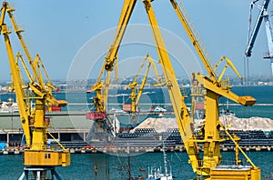 Industrial seaport infrastructure - sea, cranes and minerals, metal and bundles of wire, concept of marine cargo transportation