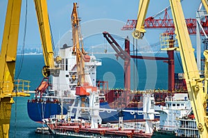 Industrial seaport infrastructure, sea, ship and cranes, concept of sea cargo transportation