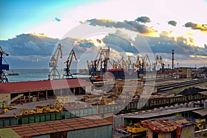 Industrial seaport with trains, wagons, containers, against the cloudy sky