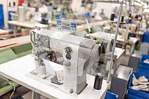 Industrial sewing machine in the work shop. Shoe manufacturing