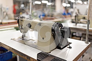 Industrial sewing machine in the work shop. Shoe manufacturing