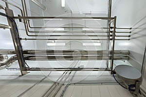 Industrial shiny steel pipeline overhead ceiling upward background. Chemical laboratory and science style.