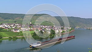 Industrial ship barge on Moselle river next to villages Beilstein and Ellenz Rhineland-Palatinate in Germany