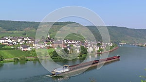 Industrial ship barge on Moselle river next to villages Beilstein and Ellenz Rhineland-Palatinate in Germany