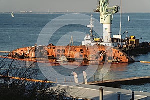 Industrial ship crane lifts old sunken tanker Delfi from Black Sea in Odessa, Ukraine 26 August 2020. Ship crashed near shore sea