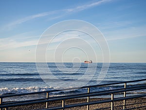 Industrial ship far out to sea. Landscape with a ship. Skyline. Sky and sea photo