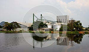 Industrial, silo near pond.