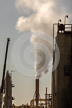 Industrial smoke stack emitting steam