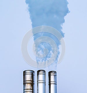 Industrial smokestack sending out hot white steam and smoke. Close up.