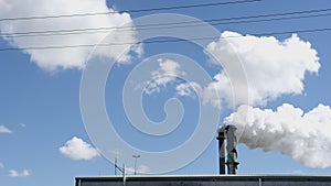 Industrial smokestack with smoke on blue sky background