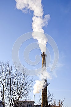 Industrial smokestack smoke on sky background