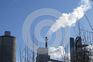 Industrial smokestack at spring against blue sky, Finland