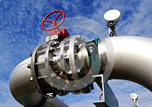 Industrial stainless Steel pipelines and valves against blue sky