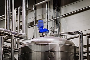 Industrial stainless steel tank in modern brewery