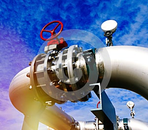 Industrial Steel pipelines and valves against blue sky