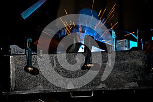 A industrial steel welder and sparks