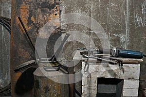 Industrial still life - tools and hardened workpieces on a wall background