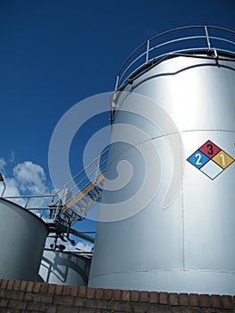 Industrial Storage Tanks for Chemicals with Safety sign