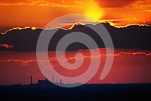 Industrial Sunset With A Coal Factory Under A Big Cloud