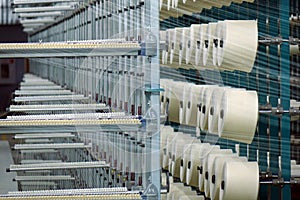 Industrial textile factory. Coils with threads in production.Fabric production .