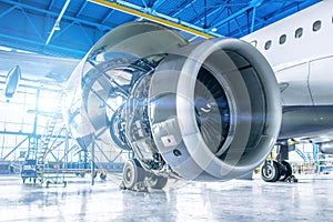 Industrial theme view. Repair and maintenance of aircraft engine on the wing of the aircraft photo