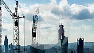 Industrial timelapse with tower cranes, high rise buildings under construction