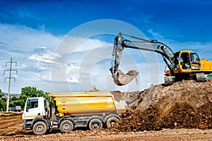 Industrial truck loader excavator and bulldozer moving earth