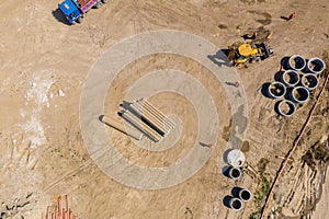 Industrial truck loader excavator moving earth and unloading. Aerial view