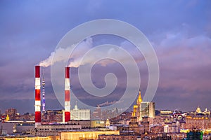 Industrial urban cityscape. Factory pipes of a city landscape in Moscow, Russia during sunset.