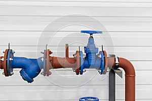 Industrial valve on a gas or heating pipe. Installation of a heating unit in a production room. Metal pipes for heating