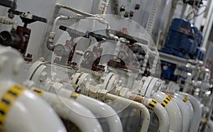 Industrial valves, pipes in modern offshore ship`s engine room