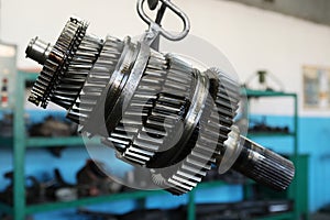 Industrial vertical gearbox. Large gears of a truck. Engine and gear shaft disassembled photo