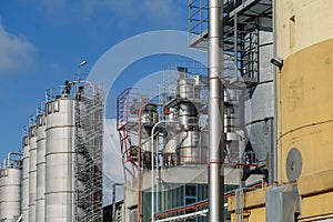 Industrial view at oil refinery plant and silos from industry zone. Refinery factory oil storage tank.View of industrial plant o