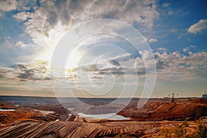 Industrial view of opencast mining quarry with machinery at work