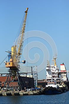 Industrial view of sea port warehouse, container cranes and ships. Import export, global logistics