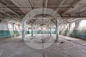 Industrial warehouse with cement walls, floors, windows and pillars before construction, remodeling, renovation