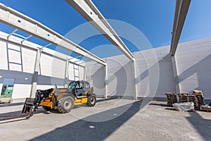 Industrial warehouse construction. Rotating telehandler vehicle