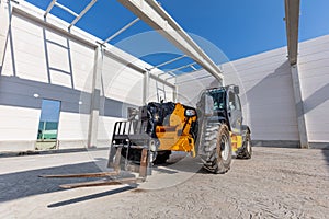 Industrial warehouse construction. Rotating telehandler vehicle