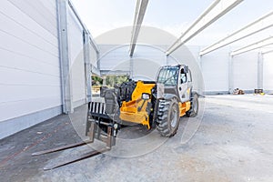 Industrial warehouse construction. Rotating telehandler vehicle