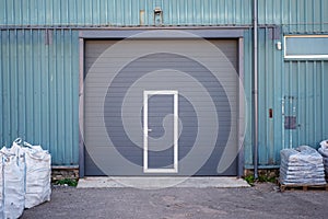 Industrial warehouse with dark grey door for vehicle.