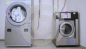 Industrial washer dryer working. Hotel laundry service. Clothes dryer machine