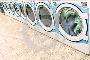 Industrial washing machines in a public Laundromat photo