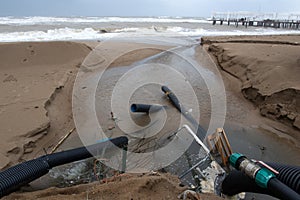 Industrial wastewater, the pipeline discharges liquid industrial waste into the sea on a city beach. Dirty sewage flows from a