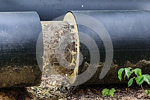 An industrial water pipe with exposed foam insulation lies on the ground. Replacement of heating pipes