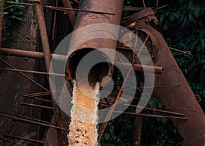 Industrial water waste with rusted old pipes