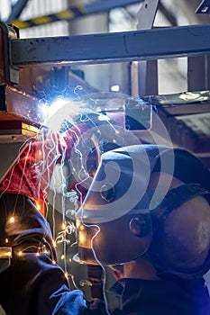 Industrial Welder With Torch And Welding Sparks Of Molten Metal