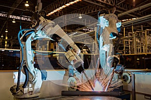 Industrial welding robots are welding in production line factory