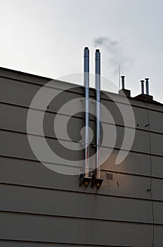 Industrial white building with sheet metal facade of repeating rectangle